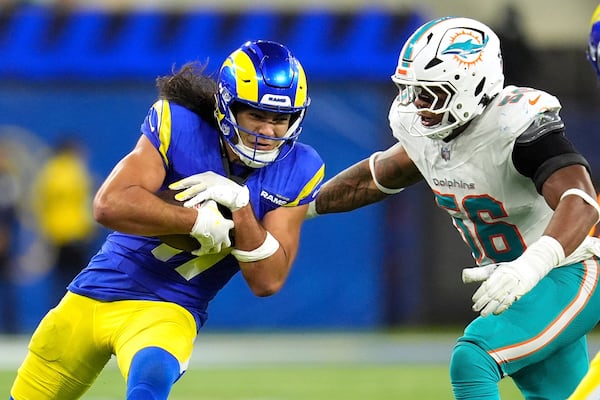 Los Angeles Rams wide receiver Puka Nacua, left, is tackled by Miami Dolphins linebacker Quinton Bell during the second half of an NFL football game, Monday, Nov. 11, 2024, in Inglewood, Calif. (AP Photo/Marcio Jose Sanchez)