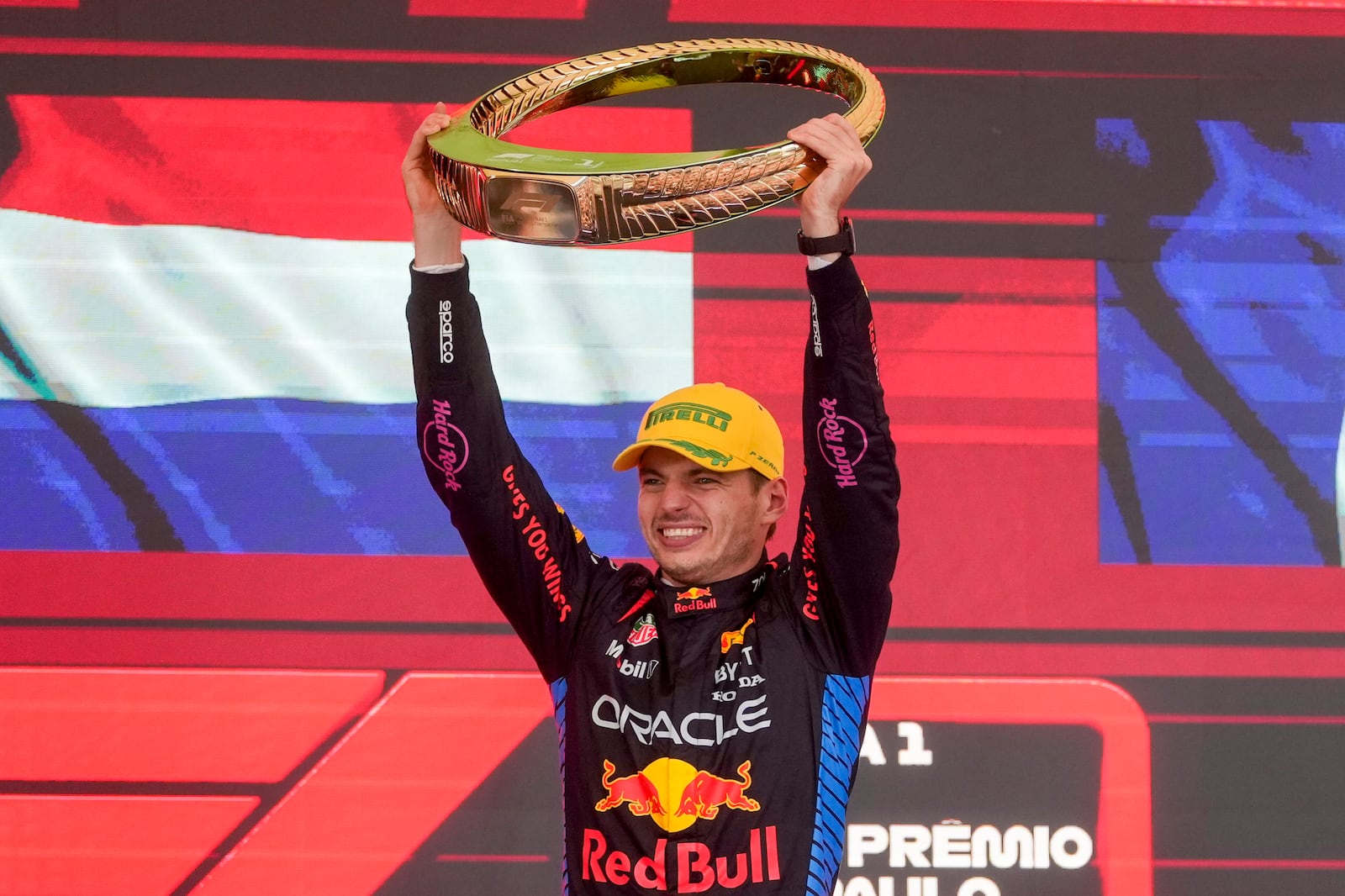 Red Bull driver Max Verstappen, of the Netherlands, celebrates on the podium his first place in the Brazilian Formula One Grand Prix at the Interlagos race track in Sao Paulo, Sunday, Nov. 3, 2024. (AP Photo/Andre Penner)