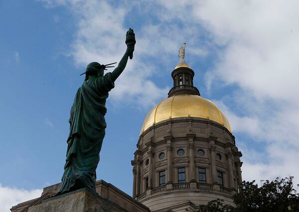 January 27, 2015 - Atlanta - The newly placed Statue of Liberty looks toward the Gold Dome. The statue was a gift from the Boy Scouts of America in the 1950's and is now located in Liberty Plaza across from the Capitol. Both the Senate and the House were in session today, With no bills ready for debate yet, both chambers focused on less serious matters. In the House, it was picture day (The Senateâ€™s is Wednesday). The House and Senate each got a visit from representatives from the smokinâ€™ hot Atlanta Hawks. BOB ANDRES / BANDRES@AJC.COM PHOTO BY BOB ANDRES / AJC