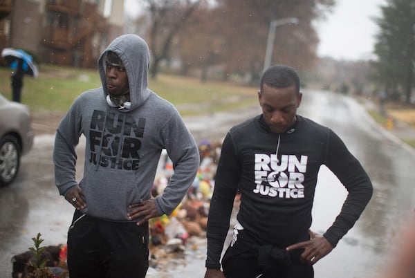 FERGUSON, MO - NOVEMBER 23: Ray Mills (L) and Londrelle Hall view the Michael Brown memorial November 23, 2014 in Ferguson, Missouri. Mills and Hall spent nearly three weeks running from Atlanta, Georgia to draw attention to Brown's death. Brown, an 18-year-old black man, was killed by Darren Wilson, a white Ferguson police officer, on August 9. His death has sparked months of sometimes violent protests in Ferguson. A grand jury is expected to decide soon if Wilson should be charged in the shooting.. (Photo by Scott Olson/Getty Images)