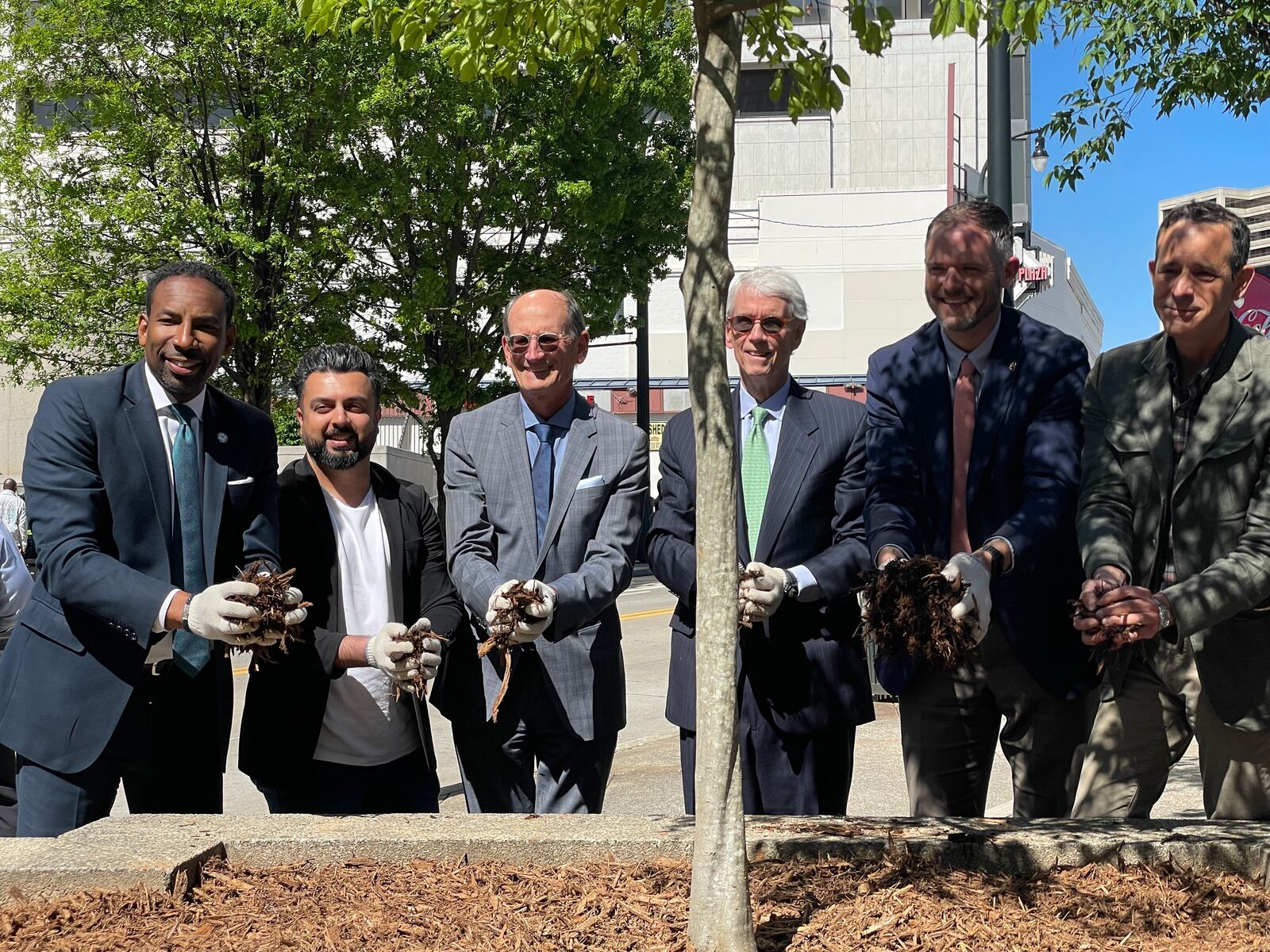 Atlanta Mayor Andre Dickens (far left) says Atlanta is going to plant 8,000 trees downtown within five years.