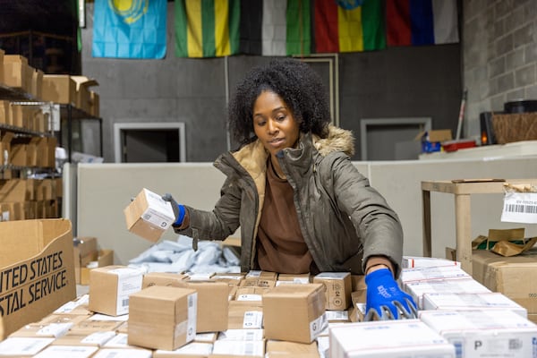 Maïré Bavarday-Rosa, founder of ECOMSPACES, works in the company’s warehouse in Atlanta on Friday, Dec. 8, 2023. (Arvin Temkar / arvin.temkar@ajc.com)