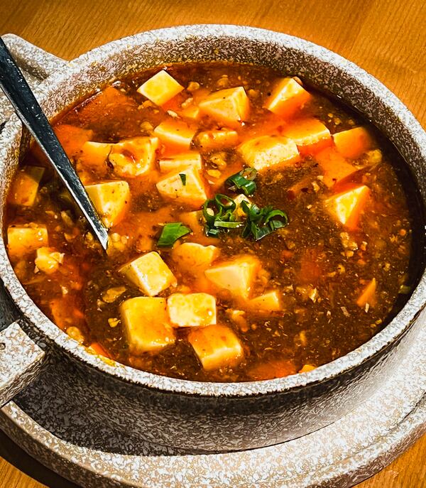 Jiang Nan's version of mapo tofu, a traditional Sichuan dish, had good flavor but very little texture. (Henri Hollis/AJC)