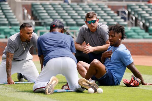 Braves infielders Orlando Arcia, Austin Riley, and Ozzie Albies interact with Braves third-base coach Ron Washington before the game against the Colorado Rockies at Truist Park on Sunday, June 18, 2023, in Atlanta. Miguel Martinez / miguel.martinezjimenez@ajc.com 