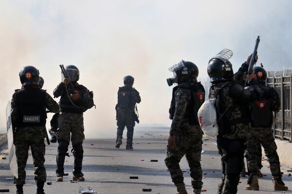 Paramilitary soldiers fire rubber bullets and tear gas shells to disperse supporters of imprisoned former premier Imran Khan's Pakistan Tehreek-e-Insaf party, during clashes at D-Chowk square close to Red Zone, which is an area that houses key government buildings, in Islamabad, Pakistan, Tuesday, Nov. 26, 2024. (AP Photo/Ehsan Shahzad)