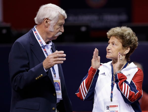 FILE - Bela Karolyi, left, and his wife, Martha Karolyi, talk on the arena floor before the start of the preliminary round of the women's Olympic gymnastics trials in San Jose, Calif., June 29, 2012. (AP Photo/Gregory Bull, File)