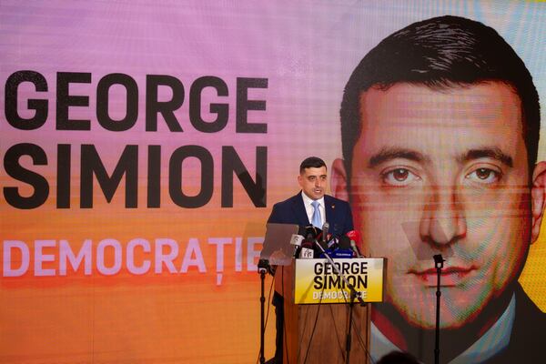 George Simion, the leader of Romania's most popular far-right party, the Alliance for the Union of Romanians (AUR), speaks in Bucharest, Romania, Friday, March 14, 2025, after filing his candidacy to participate in the country's presidential election rerun in May as he seeks to rally nationalist voters in the wake of last year's controversial frontrunner being barred from the race. (AP Photo/Vadim Ghirda)