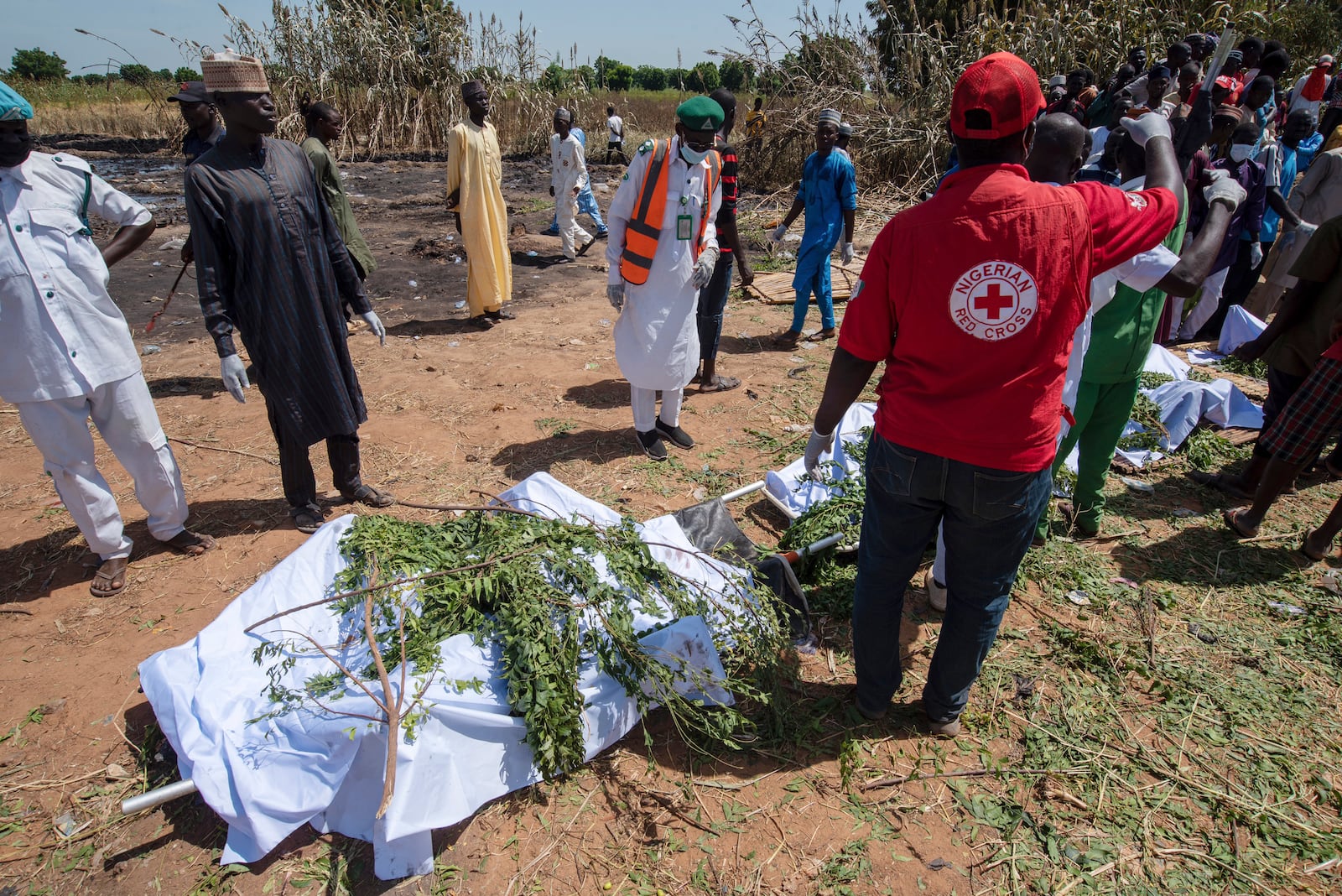 People prepare bodies for burial following a tanker explosion in Majiya town, Nigeria, Wednesday, Oct. 16, 2024. (AP Photo/Sani Maikatanga)