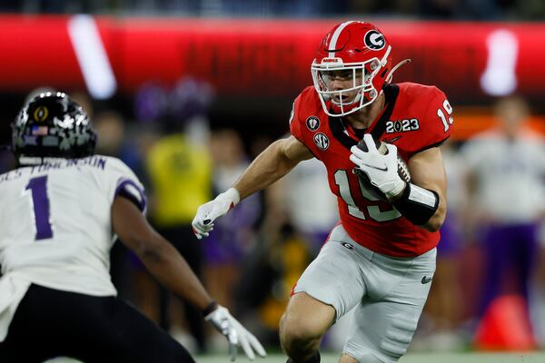 Georgia Bulldogs tight end Brock Bowers (19) runs against TCU Horned Frogs cornerback Tre'Vius Hodges-Tomlinson (1) during the first half of the College Football Playoff National Championship at SoFi Stadium in Los Angeles on Monday, January 9, 2023. (Jason Getz / Jason.Getz@ajc.com)