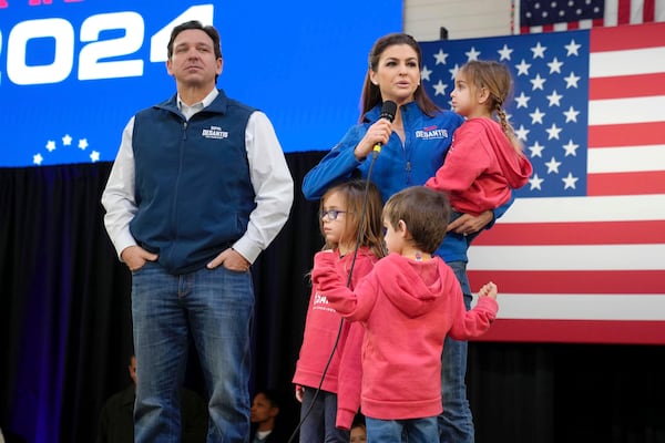 FILE - Republican presidential candidate Florida Gov. Ron DeSantis, left, looks on as his wife Casey DeSantis, carrying daughter Mamie, speaks during a campaign event at The Hangout on Saturday, Jan. 20, 2024, in Myrtle Beach, S.C. Standing in foreground are DeSantis' children Madison, left, and Mason. (AP Photo/Meg Kinnard, File)