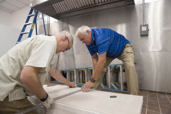 07/27/2018 — Jonesboro, Georgia —Chip Manross (left) and Randall Mathis (right) measure and place ceilings panels inside Fig Street Cafe in downtown Jonesboro, Monday, July 30, 2018. The cafe, which is owned by First Baptist Church of Jonesboro, is part of a campaign to invite people to visit and explore the city. Chip Manross is the director of facilities at First Baptist Church of Jonesboro. (ALYSSA POINTER/ALYSSA.POINTER@AJC.COM)