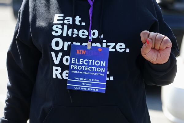 Rev. Martha Simmons wears an “election protection” badge during election day on Tuesday, November 3, 2020, at Ben Robertson Community Center in Kennesaw, Georgia. Ministers and seminary students were sent to polling locations throughout the state to monitor, offer encouragement and diffuse tense situations as a part of the New Georgia Project’s Faith Initiative. CHRISTINA MATACOTTA FOR THE ATLANTA JOURNAL-CONSTITUTION.
