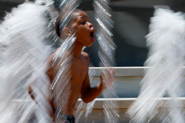 A child splashes in the water fountains at the Centennial Olympic Park as temperatures rise on Thursday, June 13, 2024.
According to the National Weather Service, the temperatures will be in the upper 90s by the weekend.
(Miguel Martinez / AJC)