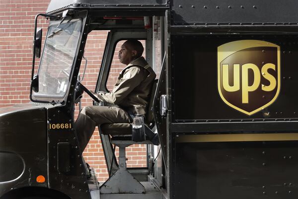 In this Tuesday, May 9, 2017, photo, a UPS driver takes his truck on a delivery route, in New York. (AP Photo/Mark Lennihan)