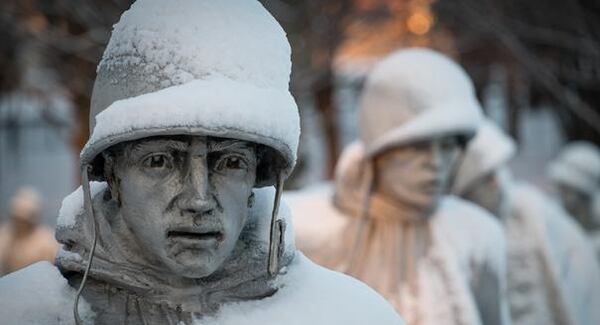 A light dusting of snow from an overnight storm covers the statutes at the Korean War Memorial in Washington early Friday morning Jan. 3, 2014. After a storm blew through the Washington region overnight, roads are being cleared and many schools systems are closed. The federal government and the District of Columbia government will be open Friday, but workers have the option to take leave or telework. (AP Photo/J. David Ake)