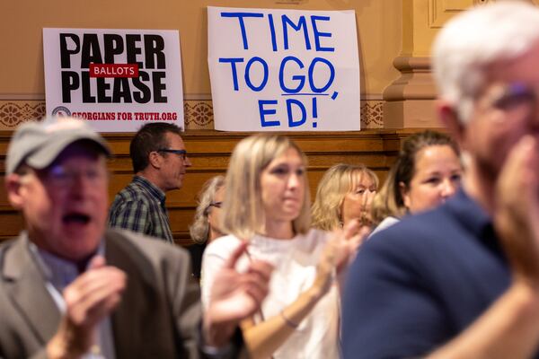 Voters skeptical of Georgia's election technology clap during public comment at a State Election Board meeting at the Capitol in Atlanta on Tuesday, May 7, 2024. (Arvin Temkar / AJC)