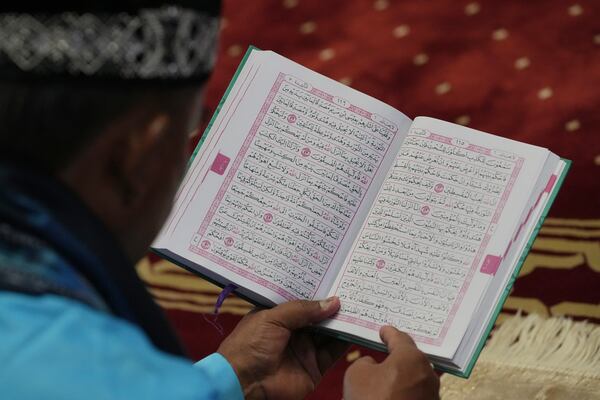 A Muslim man reads Quran during the first day of the holy fasting month of Ramadan at Istiqlal mosque in Jakarta, Indonesia, Saturday, March 1, 2025. (AP Photo/Achmad Ibrahim)