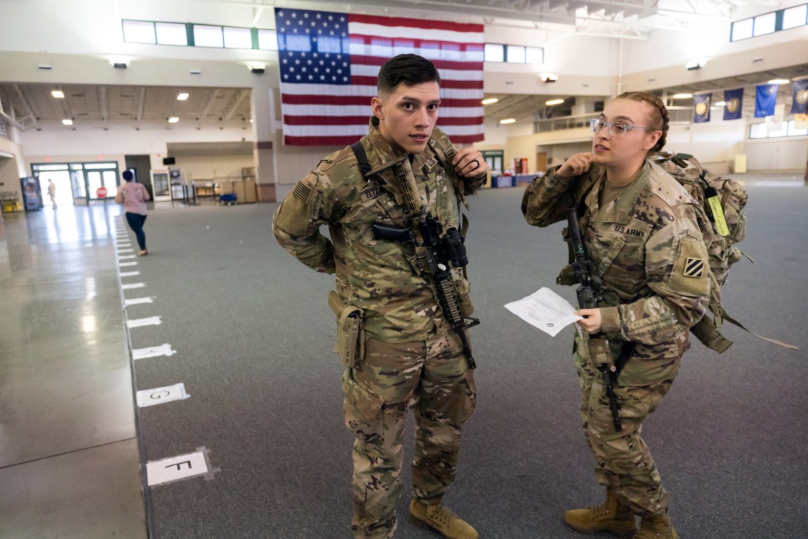 SAVANNAH, GA - MARCH 2, 2022: Marissa Elizardo, right, and her husband Michael Elizardo, left, prepare to deploy to Germany with the U.S. Army 3rd Infantry Division, 1st Armored Brigade Combat Team, Wednesday Mar. 2, 2022 in Savannah, Ga. The 180 troops on the flight are being sent as reinforcements for various NATO allies in Eastern Europe. (AJC Photo/Stephen B. Morton)