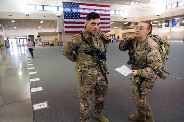 SAVANNAH, GA - MARCH 2, 2022: Marissa Elizardo, right, and her husband Michael Elizardo, left, prepare to deploy to Germany with the U.S. Army 3rd Infantry Division, 1st Armored Brigade Combat Team, Wednesday Mar. 2, 2022 in Savannah, Ga. The 180 troops on the flight are being sent as reinforcements for various NATO allies in Eastern Europe. (AJC Photo/Stephen B. Morton)