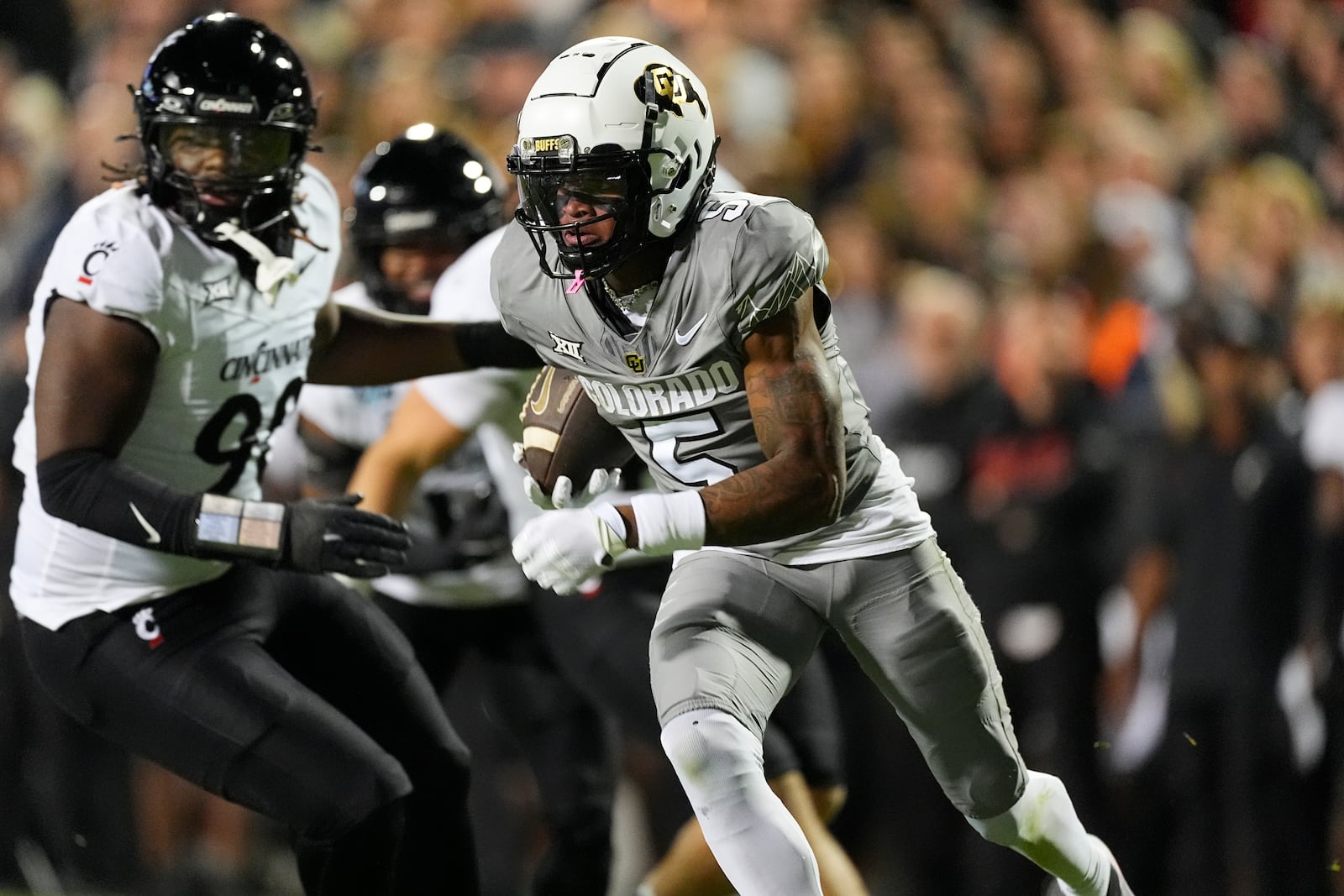 Colorado wide receiver Jimmy Horn Jr., front, avoids Cincinnati defenders for a short gain after catching a pass in the first half of an NCAA college football game Saturday, Oct. 26, 2024, in Boulder, Colo. (AP Photo/David Zalubowski)