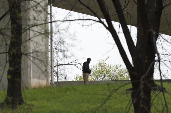 Hill stands under a bridge near I-20 and the Downtown Connector Monday. (DAVID BARNES / DAVID.BARNES@AJC.COM)