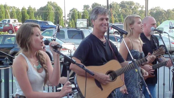 Many of the earliest performances by Foxes and Fossils were in humble surroundings, including this parking lot. they are, from the left, Maggie Adams, Tim Purcell, Sammie Purcell and the late Scott King. Photo: Foxes and Fossils