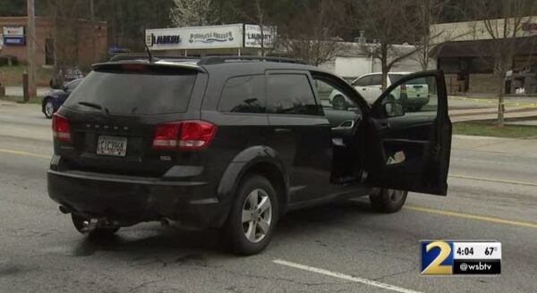 Police said a man and woman were arguing in this Dodge Journey before the man shot her. 