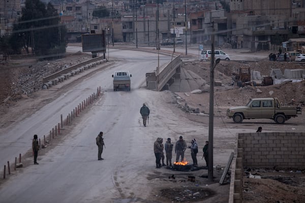 FILE - Kurdish-led fighters backed by the U.S. man a checkpoint in Hassakeh, Syria, on Jan. 24, 2022. (AP Photo/Baderkhan Ahmad, File)