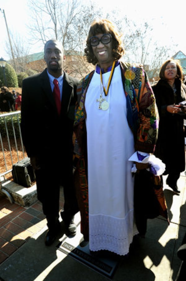 James Taylor stands with his grandmother, Bishop Barbara King of Hillside International Chapel and Truth Center Inc., during her induction.