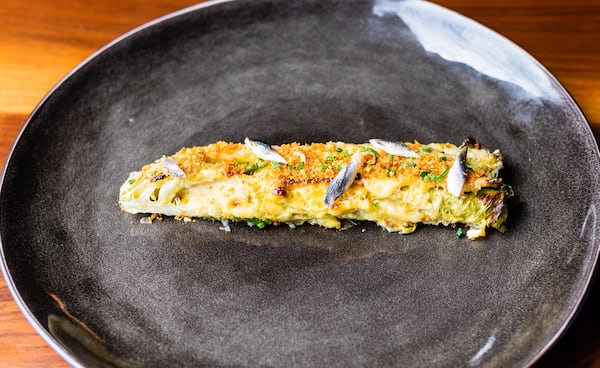 Roasted romaine lettuce with boquerones (anchovies) and Parmesan crumbs can serve as a snack at Lazy Betty. CONTRIBUTED BY HENRI HOLLIS