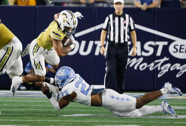 Georgia Tech Yellow Jackets running back Dontae Smith (4) runs for a first down during the fourth quarter of an NCAA football game In Atlanta on Saturday, Oct. 28, 2023 between the Georgia Tech Yellow Jackets and the North Carolina Tar Heels.  Georgia Tech won, 46-42.  (Bob Andres for the Atlanta Journal Constitution)