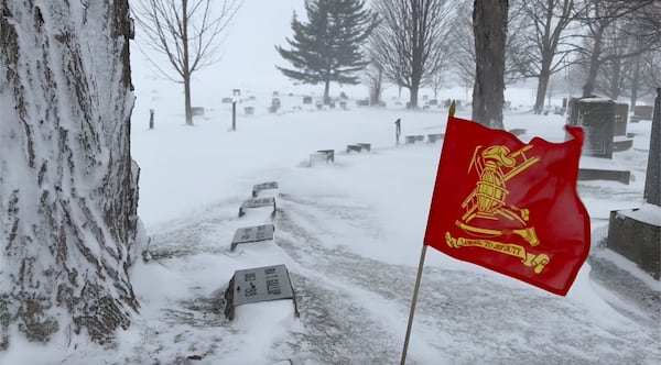 A flag waves during high winds in Lowville, N.Y. on Thursday, Dec. 12, 2024. (AP Photo/Cara Anna)