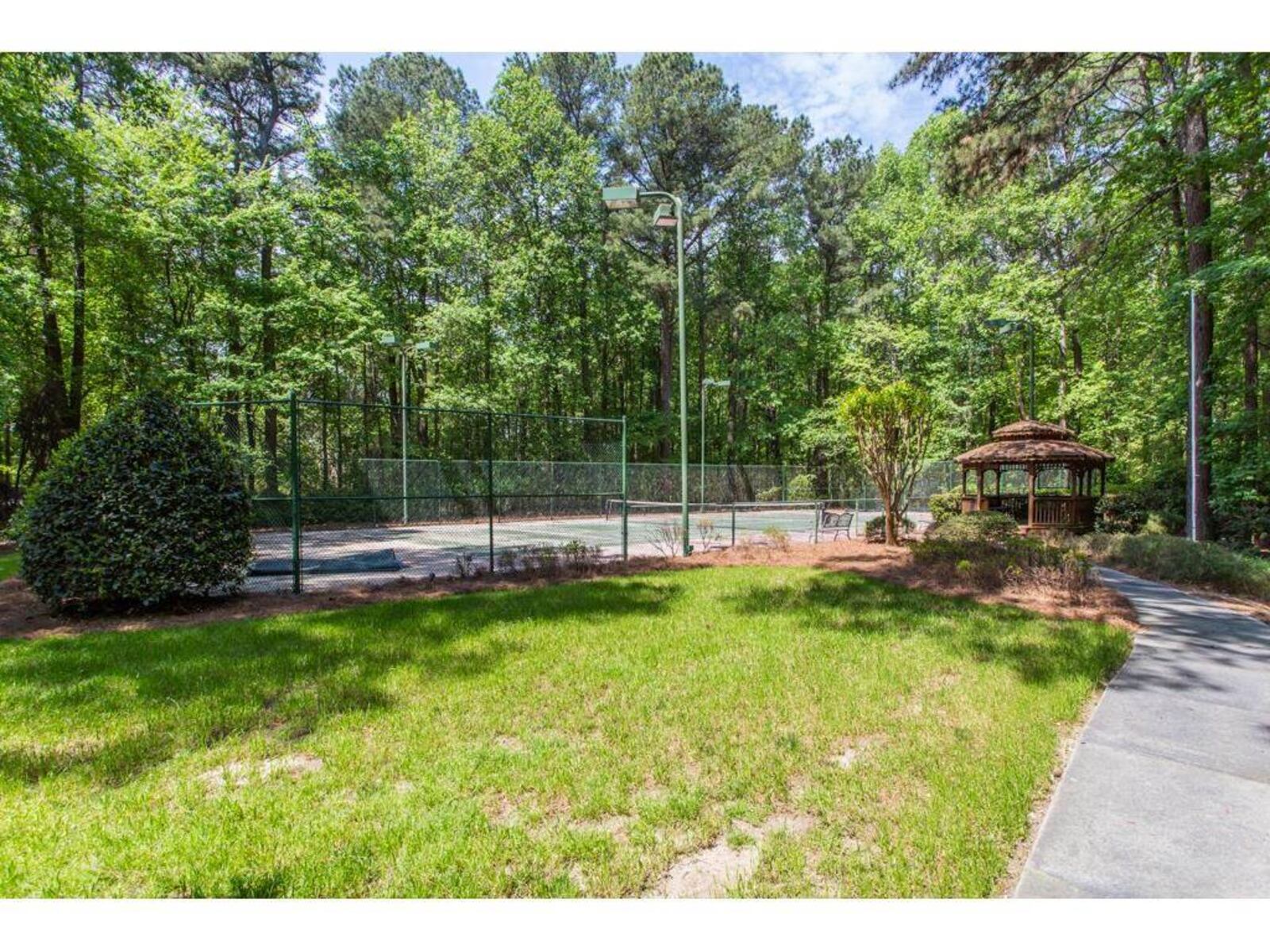 A $3.75 million home in Snellville has a movie theater, two fitness centers and multiple sports facilities, including this tennis court.