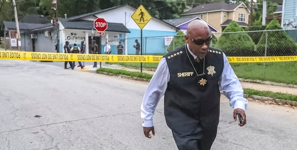 July 10, 2019  Atlanta : Clayton County Sheriff, Victor Hill leaves the scene where Atlanta police, Clayton County sheriff deputies along with the Clayton County Police Department investigated the scene on Griffin Street in northwest Atlanta after a wanted man killed himself on Wednesday July 10, 2019. A jilted Clayton County husband who confessed to his wife’s shooting on social media killed himself Wednesday when he was approached by officers in northwest Atlanta, authorities said. Atlanta police and Clayton County sheriff’s deputies tracked Orlando Rodriguez Otero’s vehicle to the area of Griffin Street around 5 a.m. With the help of a K-9, they found him standing in a grassy area outside an apartment complex at the corner of Griffin and North Avenue, Atlanta police Capt. William Ricker told AJC.com. “When the officers spotted him, he had a firearm and a phone in his hand,” Ricker said. “Shortly thereafter, he put the gun to his head and shot himself.” Clayton County authorities had been looking for Otero since he allegedly shot his wife at their Morrow Road apartment late Tuesday night.  According to the sheriff’s office, Otero’s son called 911 from inside a locked bathroom to report his father and mother were fighting. The child also told dispatchers he heard gunshots. When police got to the apartment, Otero was gone. They found the woman shot three times in the face, head and stomach, a sheriff’s spokesman said in a news release. She remains in critical condition and is “fighting for her life.” “Clayton County police detectives found that the shooting suspect, who they identified as Orlando Rodriguez Otero, shot his wife after an argument and left the scene saying that she would be all right,” the spokesman said. “... Otero then made a live social media post confessing to shooting his wife over another man.” Atlanta police were processing the suicide scene Wednesday morning. Clayton County Sheriff Victor Hill was also on scene.