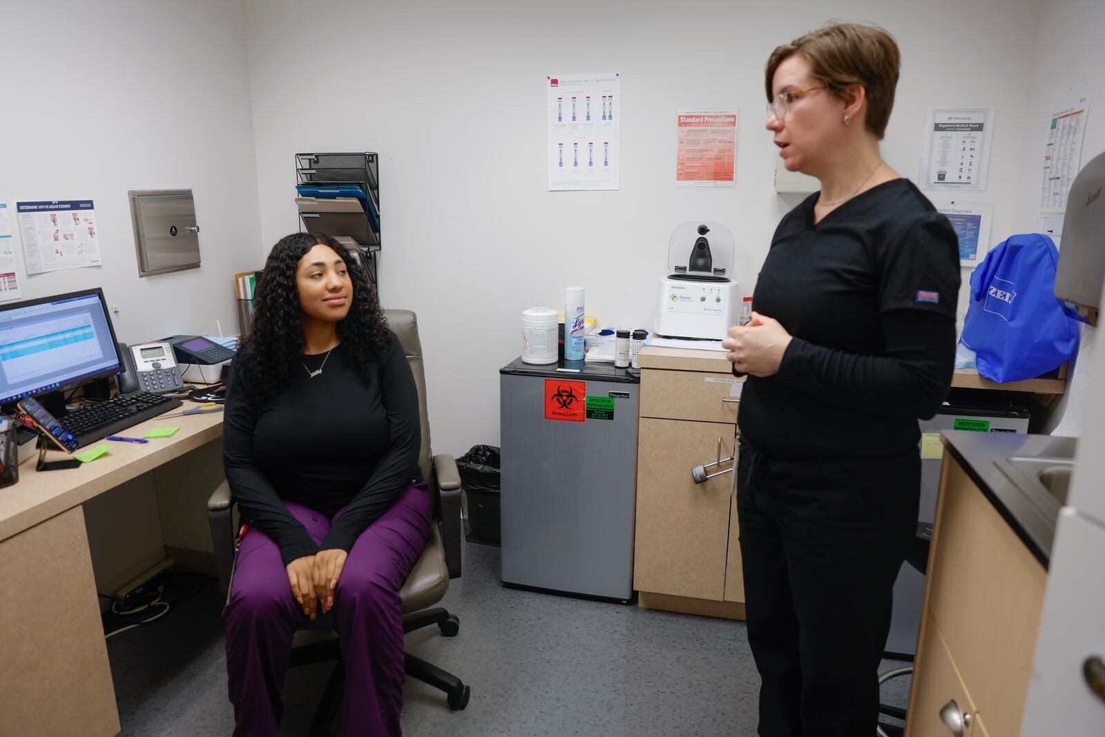 (Left to right) The Empowerment Resource Center medical assistant Mellenia Brown and nurse practitioner Lauren Allan chat on Tuesday, June 20, 2023. The clinic in Atlanta receives federal Title X money to provide individuals with comprehensive family planning and related preventive health services. (Natrice Miller/ Natrice.miller@ajc.com)