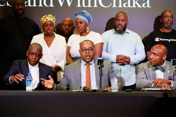 Attorney Dave Banks (center) speaks about Chaka Zulu's murder charge. Miguel Martinez / miguel.martinezjimenez@ajc.com 