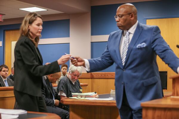 June 6, 2017 Atlanta:  Deputy DA Lyndsey Rudder (left) and Fulton Assistant District Attorney Clint Rucker (right) begin the signing as Atlanta attorney, Claud "Tex" McIver (center) was arraigned for murder on Tuesday, June 6, 2017.  McIver shot his wife Diane as they rode in their SUV in midtown Atlanta in the fall of 2016. JOHN SPINK/JSPINK@AJC.COM.