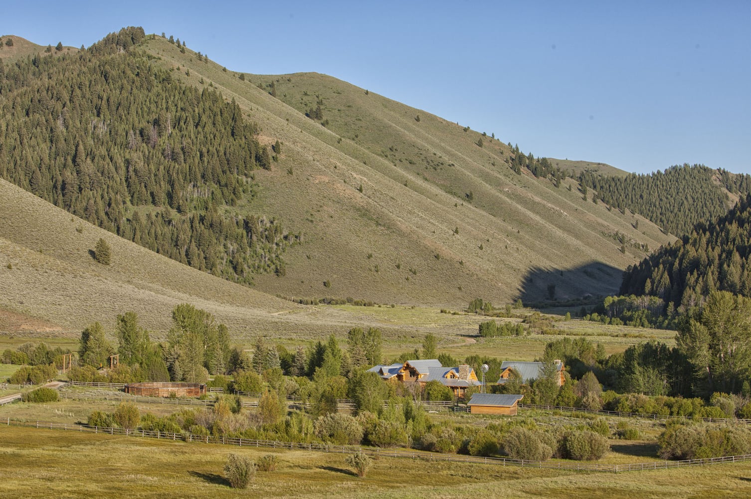 500-acre property has log cabins, mountain views