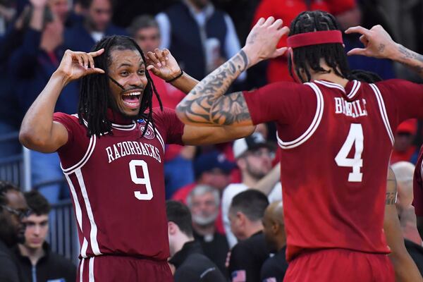 Arkansas forward Jonas Aidoo (9) celebrates with Trevon Brazile (4) after defeating Kansas after their game in the first round of the NCAA college basketball tournament, Thursday, March 20, 2025, in Providence, R.I. (AP Photo/Steven Senne)