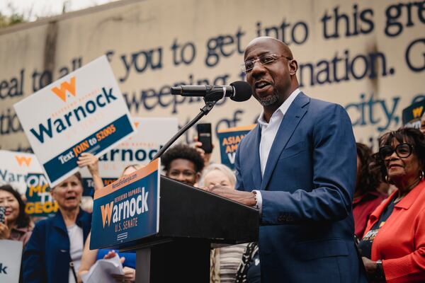 Sen. Raphael Warnock, D-Ga., speaks by a mural of John Lewis in Atlanta, as Georgia’s Senate election headed to a runoff contest, on Nov. 10, 2022. neither Senate candidate cleared 50% of the vote, triggering the Dec. 6 matchup. “You have to admit that I did warn y’all that we might be spending Thanksgiving together,” Warnock said. “And here we are.” (Nicole Craine/The New York Times)