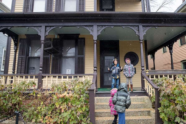 A light rain falls as Rico Aaron, Jr. (left) and Makalyn Ross (right) take their post for a photo opportunity at the birth home of Martin Luther King, Jr. at the Martin Luther King, Jr. National Historical Park in Atlanta, Thursday, January 17, 2019. 