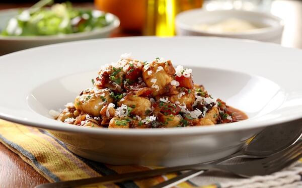 A sauce of tomatoes and pancetta is bolstered with sauteed leeks, shallots and bell pepper. Then prunes are added for body and sweetness. It's all used to dress the gnocchi. (Michael Tercha/Chicago Tribune/TNS)