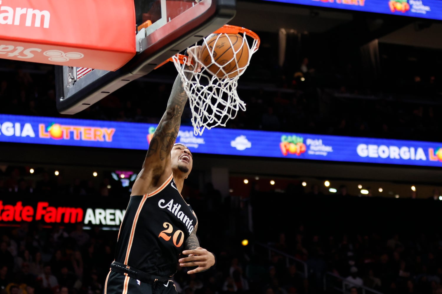 Hawks forward John Collins goes up for a dunk  
during the first half against the Magic on Monday night in Atlanta. (Miguel Martinez / miguel.martinezjimenez@ajc.com)