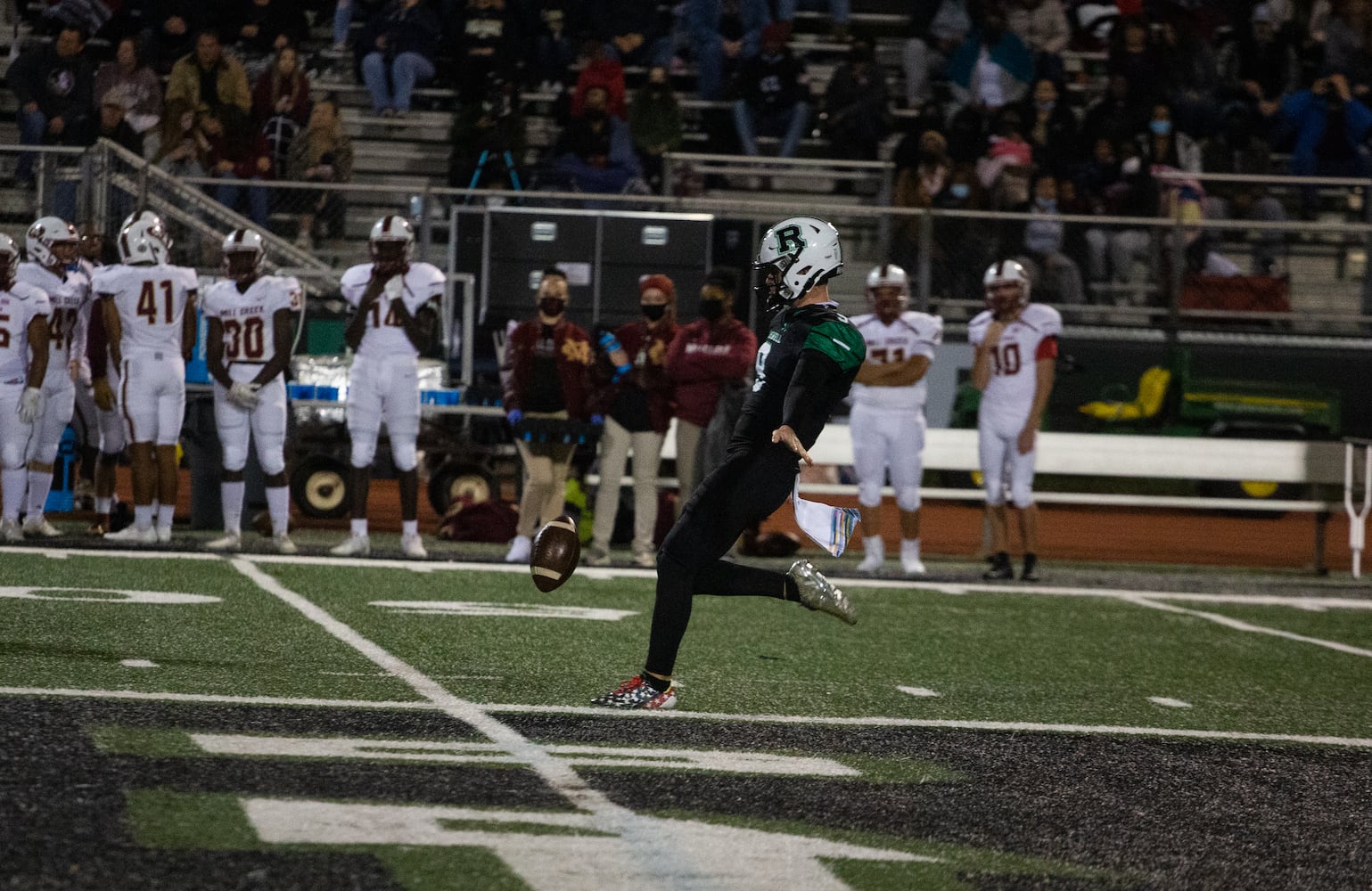 Caden Long, senior kicker for Roswell, punts the ball during the Mill Creek vs. Roswell high school football game on Friday, November 27, 2020, at Roswell High School in Roswell, Georgia. Mill Creek led Roswell 27-21 at the end of the third quarter. CHRISTINA MATACOTTA FOR THE ATLANTA JOURNAL-CONSTITUTION