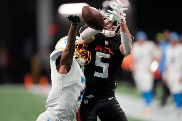 Los Angeles Chargers cornerback Kristian Fulton (7) breaks up a pass intended for Atlanta Falcons wide receiver Drake London (5) during the second half of an NFL football game on Sunday, Dec. 1, 2024 in Atlanta. (AP Photo/John Bazemore)