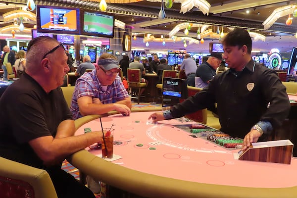 A dealer conducts a card game at the Hard Rock casino in Atlantic City, N.J., on Oct. 3, 2024, a month in which internet gambling set a new revenue record in New Jersey at $213 million. (AP Photo/Wayne Parry)