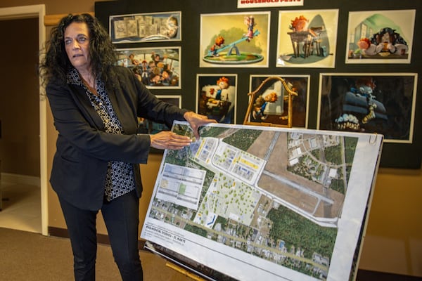 Pigmental Studios creative director and CEO Marina Martins shows illustrations of recently purchased property in September in St. Marys, Ga. Gary McCullough/AJC