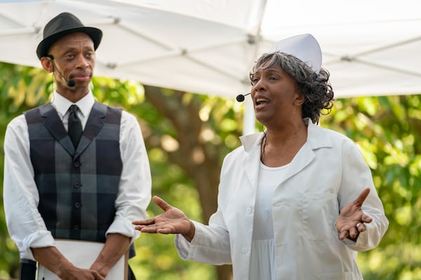 A woman in costume speaks to tour goers. Atlanta residents celebrate at the Oakland Cemetary Juneteenth Family Festival. This is the third Juneteenth since becoming a federal holiday in 2021. Saturday, June 15, 2024 (Ben Hendren for the Atlanta Journal-Constitution)