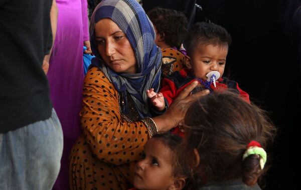 Syrian refugees rest after crossing into Jordanian territory near the town of Ruwaished, 149 miles east of Amman. AP Photo/Raad Adayleh