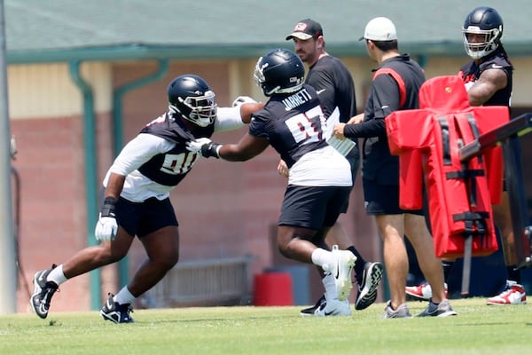 Falcons lineman David Onyemata (90), right, works with lineman Grady Jarrett (97) during OTAs at the Atlanta Falcons Training Camp, Wednesday, June 7, 2023, in Flowery Branch, Ga.  (Miguel Martinez/The Atlanta Journal-Constitution/TNS)